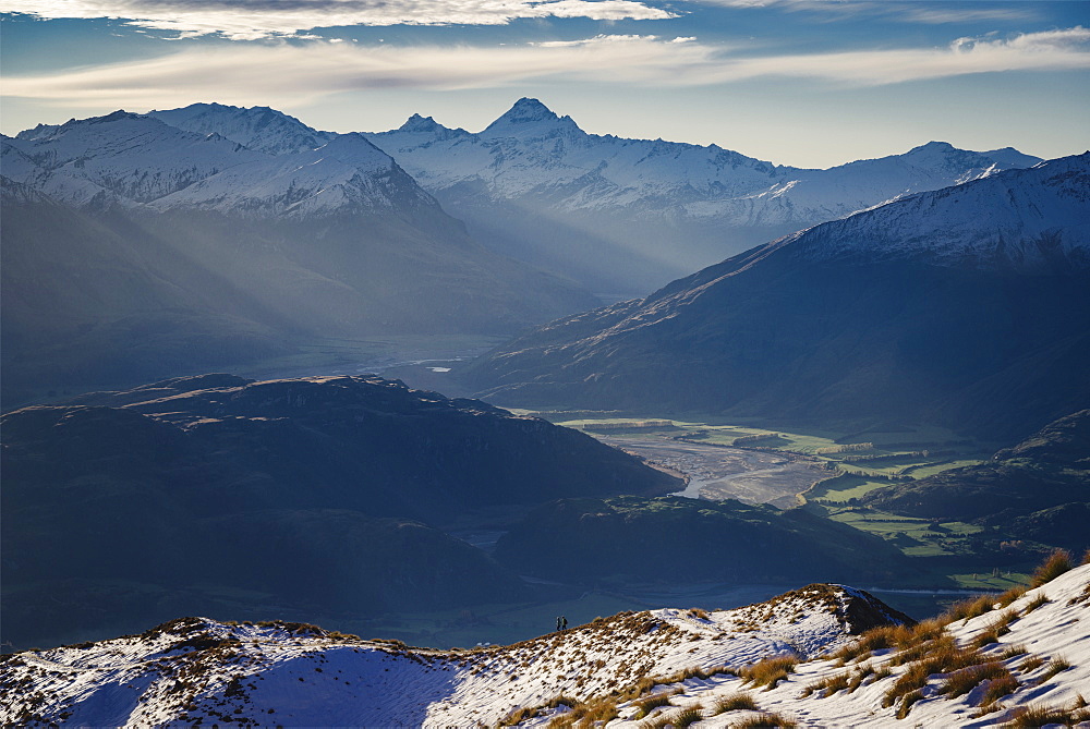 Hiking along the mountain ranges with a view of Mount Aspiring, Otago, South Island, New Zealand, Pacific