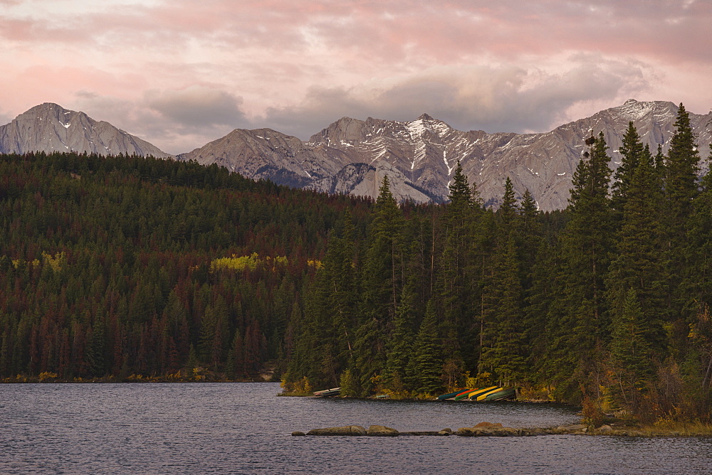 Canoes by the lakes and mountains of the Canadian Rockies, Alberta, Canada, North America