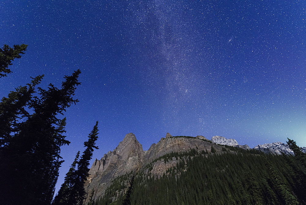 Milky way rises over the Canadian Rockies in the Yoho National Park, with moonlight cast on the mountain and Aurora over horizon, UNESCO World Heritage Site, Canadian Rockies, Alberta, Canada, North America