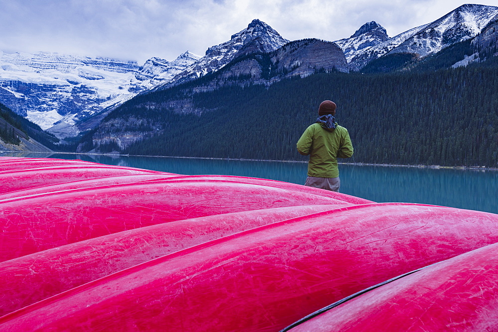 Traveler at the canoe house of Lake Louise, Banff National Park, UNESCO World Heritage Site, Canadian Rockies, Alberta, Canada, North America