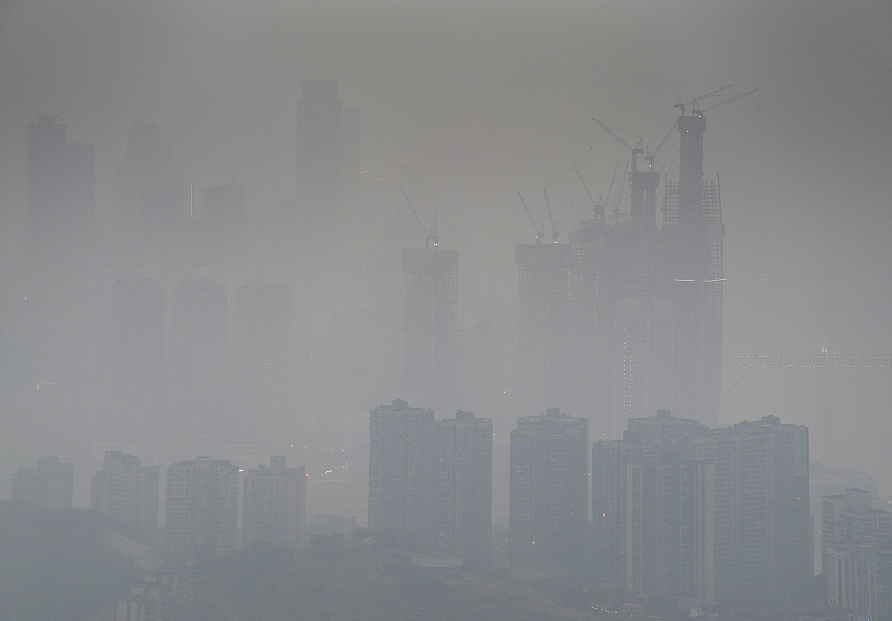 Skyline in heavy fog of the city of Chongqing under construction, Chongqing, China, Asia