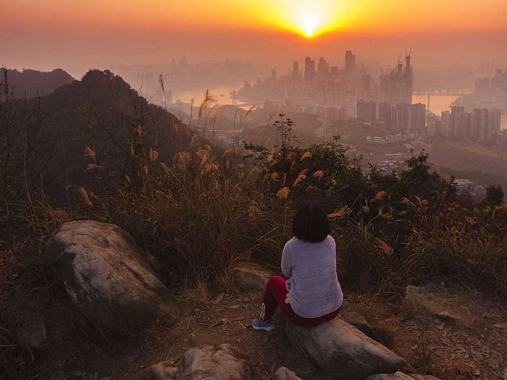 Tourist enjoys watching sunset of Chongqing skyline from the Nanshan mountain, Chongqing, China, Asia