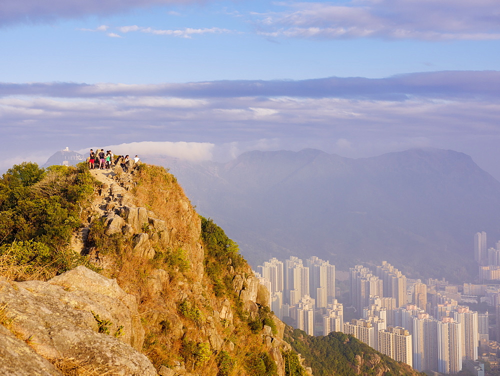 Hikers at the Lion Rock mountain peak, viewing the city of Hong Kong from a high point, Hong Kong, China, Asia