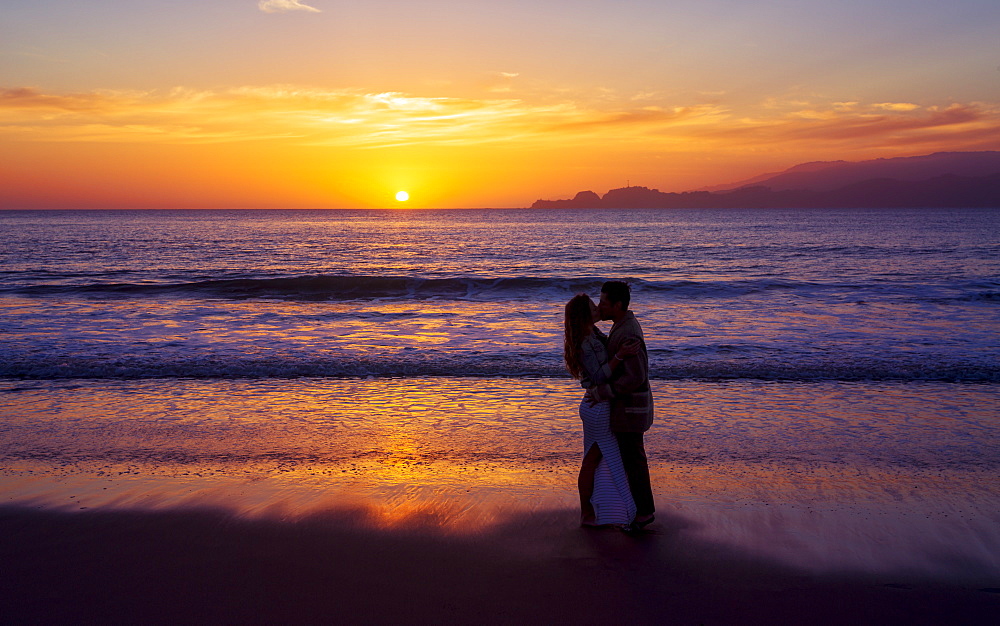 Sunset and couple in love near the Golden Gate Bridge, Baker Beach, San Francisco, California, United States of America, North America