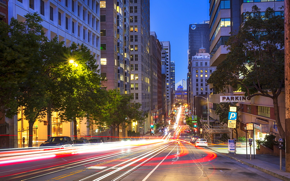 Car trail lights on Bush Street, Oakland Bay Bridge in the background, San Francisco, California, United States of America, North America