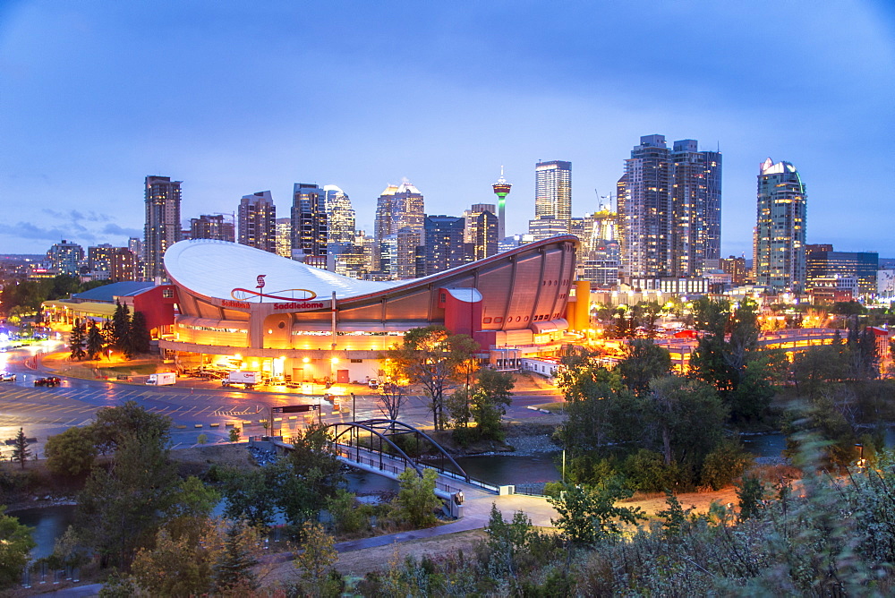 View of the Saddledome and Downtown skyline from Scottsman Hill at dusk, Calgary, Alberta, Canada, North America