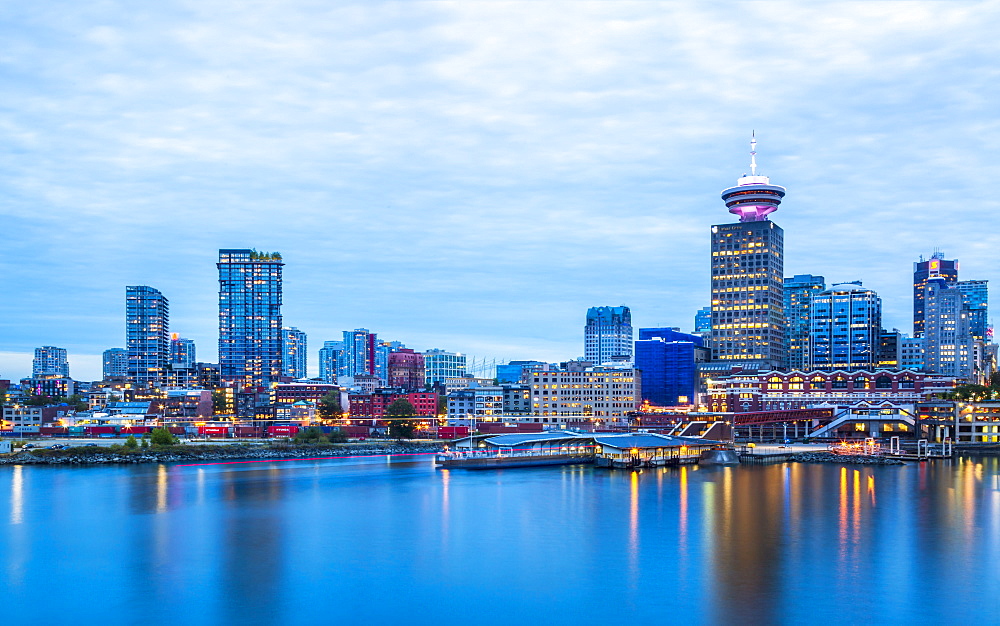 City skyline including Vancouver Lookout Tower as viewed from Canada Place at dusk, Vancouver, British Columbia, Canada, North America