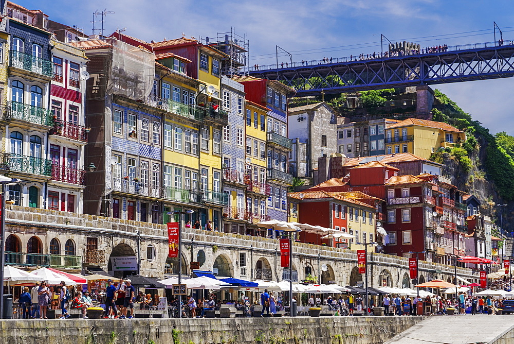 Traditional colourful buildings with balconies and umbrellas on the bank of Douro River in the Ribeira District, Porto, Portugal, Europe