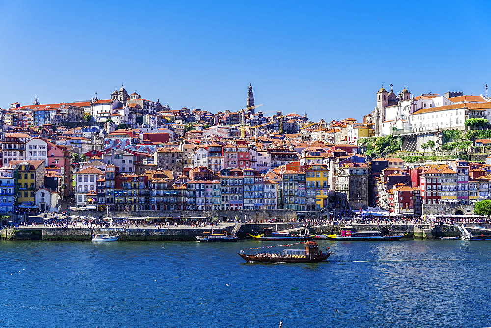 Boats on the Douro River and traditional houses of Ribeira District seen from Vila Nova de Gaia district, Porto, Portugal, Europe