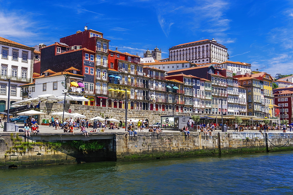 Traditional waterfront houses in the Ribeira district on the Douro River with crowd on river bank, Porto, Portugal, Europe