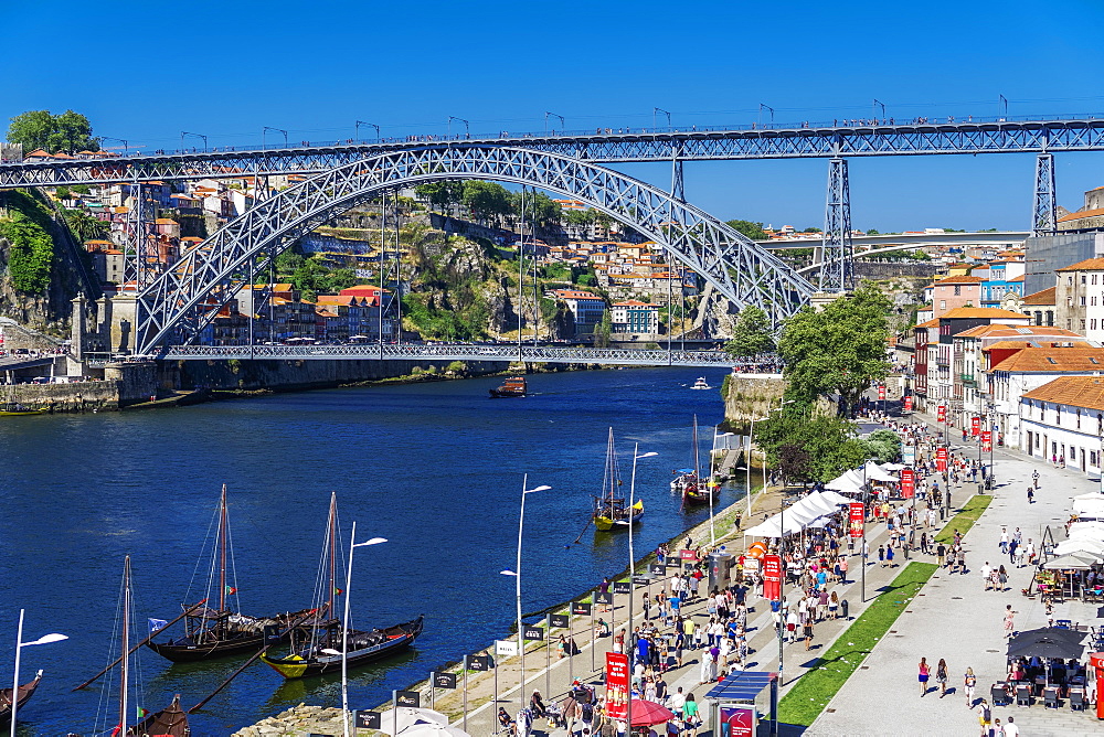 View of Dom Luis I Bridge over Douro River and Vila Nova de Gaia waterfront with Porto wine ships and Ribeira view, Porto, Portugal, Europe