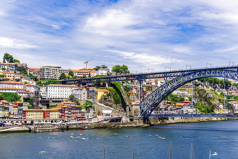 View of Dom Luis I bridge over Douro River and Ribeira view with traditional buildings and Funicular of Guindais, Porto, Portugal, Europe