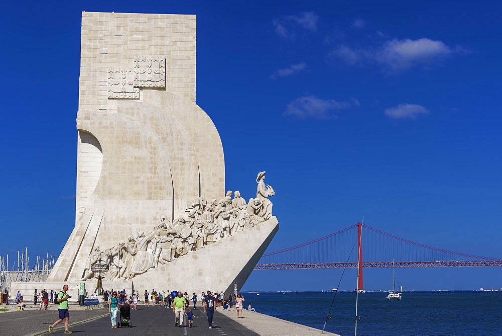 Tourists at the caravel shaped Padrao dos Descobrimentos (Monument to the Discoveries) in front of the 25 de Abril Bridge, Belem, Lisbon, Portugal, Europe