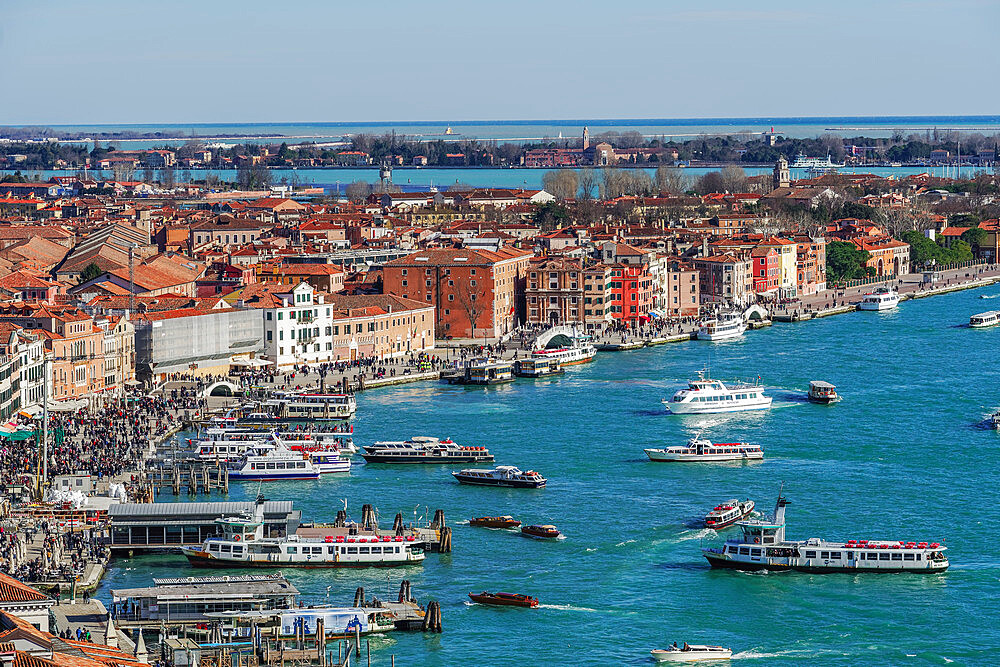 Panoramic day view of waterfront with boats and low rise buildings with red tiles, seen from St. Marks Campanile, Venice, UNESCO World Heritage Site, Veneto, Italy, Europe