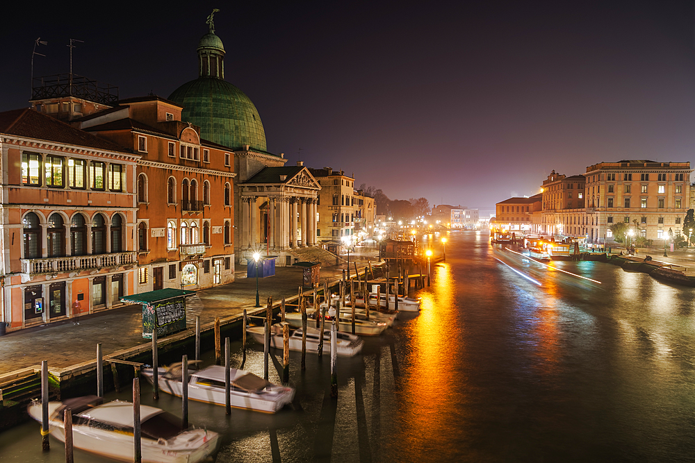 Grand Canal night view of San Simeon Piccolo with traditional buildings and wooden wharf pilings with moored boats, Venice, UNESCO World Heritage Site, Veneto, Italy, Europe