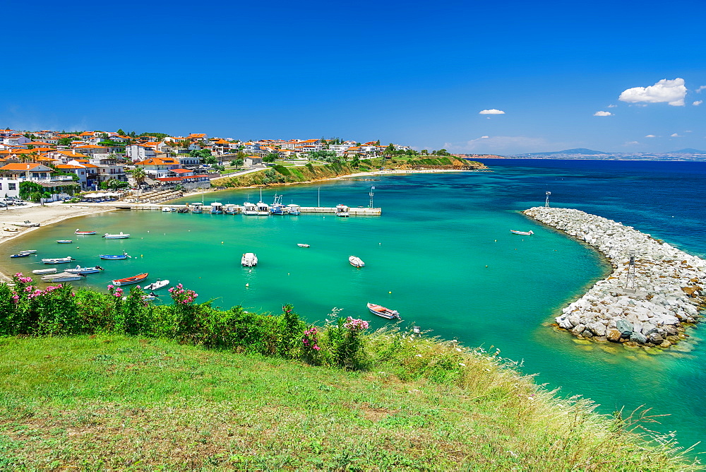 Coastal village with fishing port, hilltop view of Nea Fokaia at Kassandra peninsula with low rise buildings, Chalkidiki, Greece, Europe