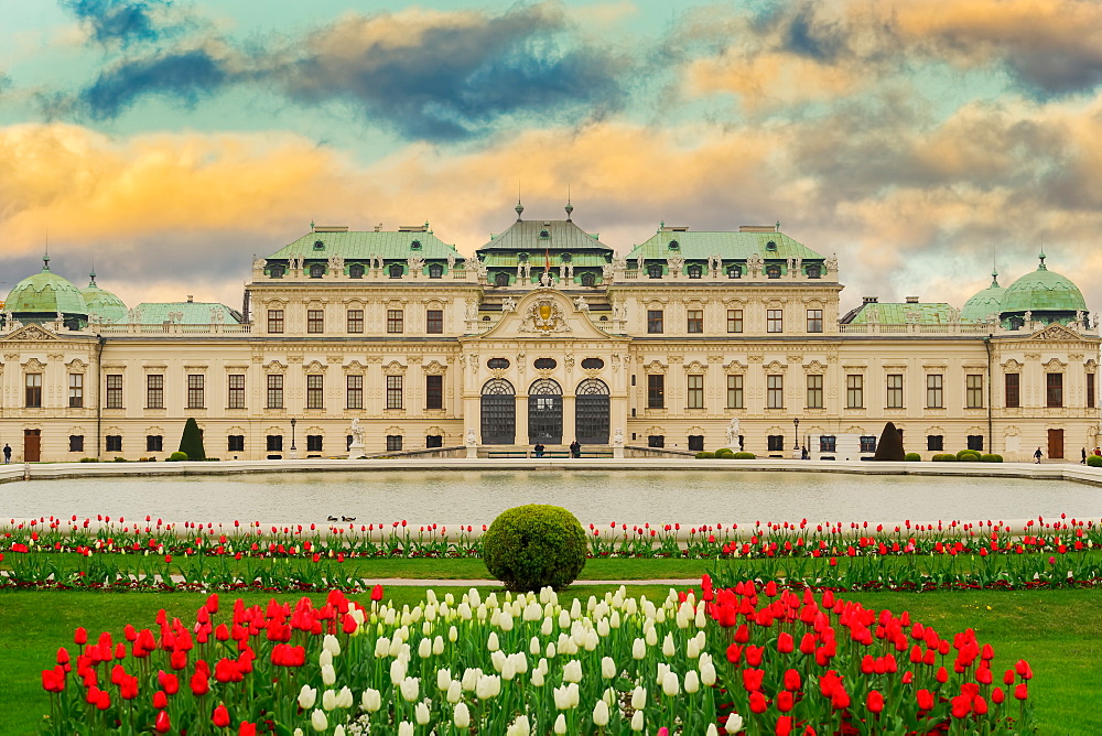 Exterior landscape of 18th century building, with garden flowers and pond, Upper Belvedere Baroque Palace, Vienna, Austria, Europe