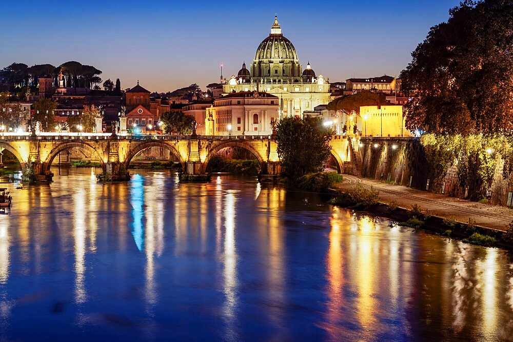 Night view of San Angelo Bridge on River Tiber with background of illuminated St. Peter's Basilica in the Vatican, Rome, Lazio, Italy, Europe