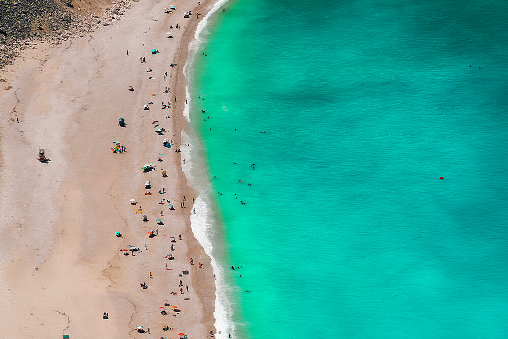 Myrtos beach panorama with crystal clear waters and unidentifiable bathers, Kefalonia island, Greek Islands, Greece, Europe