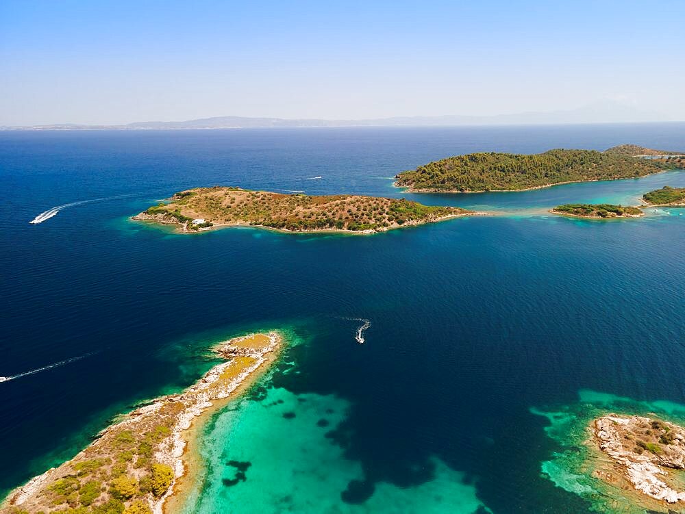 Mediterranean Greek landscape beach drone shot above Sithonia Chalkidiki peninsula, with small islands and clear waters.