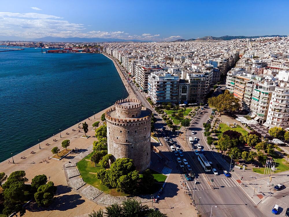 Thessaloniki, Greece aerial drone view of White Tower landmark with residential buildings at Leoforos Nikis calm seafront.