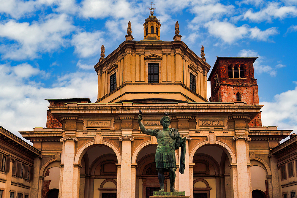 Christian church Basilica San Lorenzo Maggiore facade under a sky with clouds in Milan, Italy.