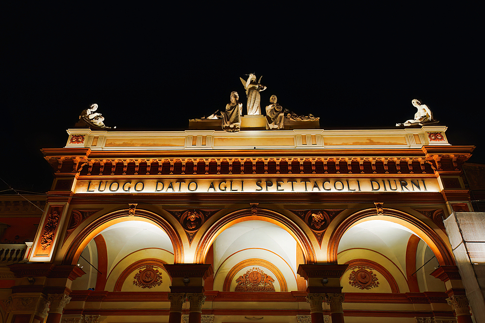 Low angle view of 1810 Arena del Sole theater facade at night, Bologna, Emilia Romagna, Italy, Europe