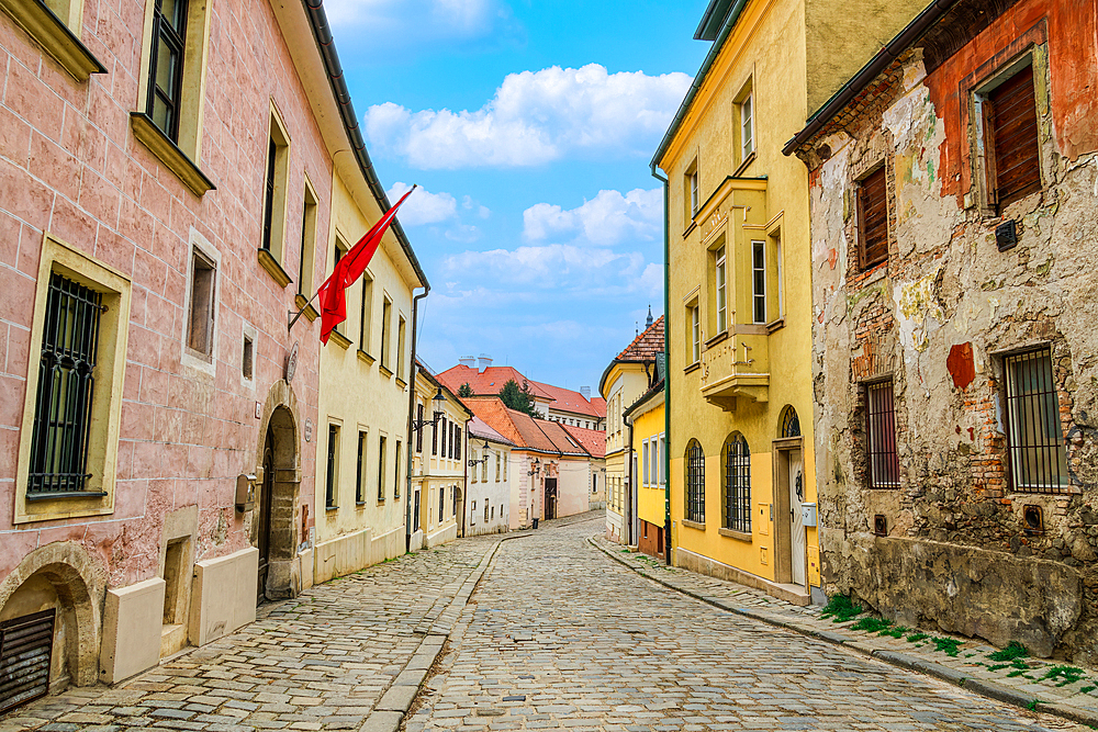 Historic low rise buildings with traditional architecture around a cobblestone street in the Old Town of Bratislava, Slovakia, Europe