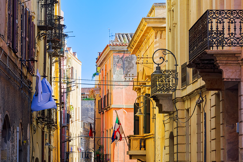 Historic center colorful buildings with wooden window shutters and iron balconies under clear blue sky, Cagliari, Sardinia, Italy, Mediterranean, Europe