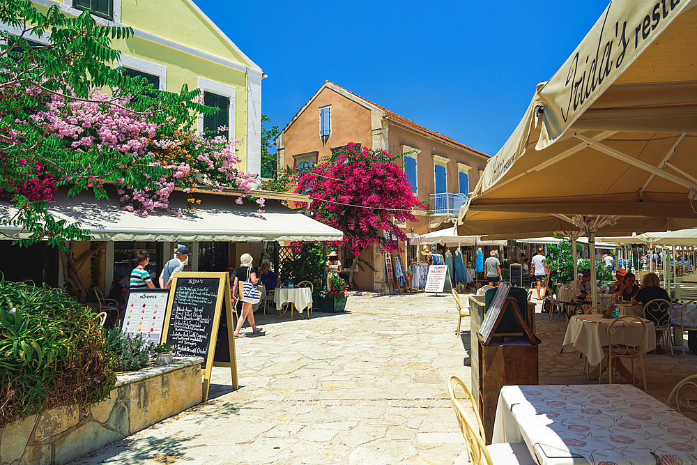 Waterfront shops and tourists in the waterfront of Fiscardo village, Kefalonia, Ionian Island, Greek Islands, Greece, Europe