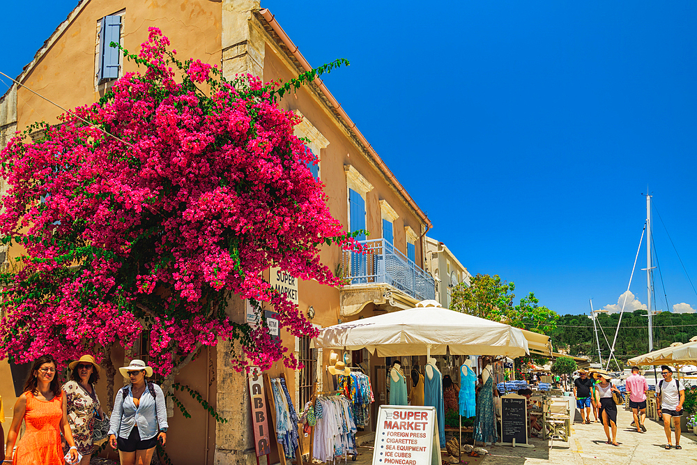 Waterfront shops and tourists in the waterfront of Fiscardo village, Kefalonia, Ionian Island, Greek Islands, Greece, Europe