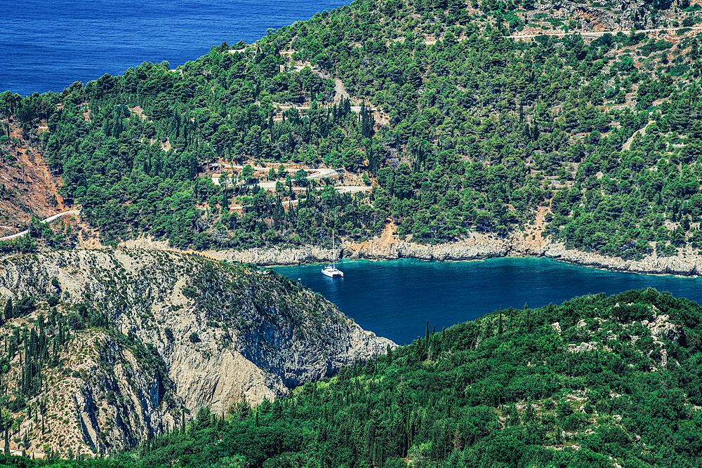 Rural landscape with moored yacht in a safe harbor surrounded by green vegetation, Kefalonia, Ionian Islands, Greek Islands, Greece, Europe