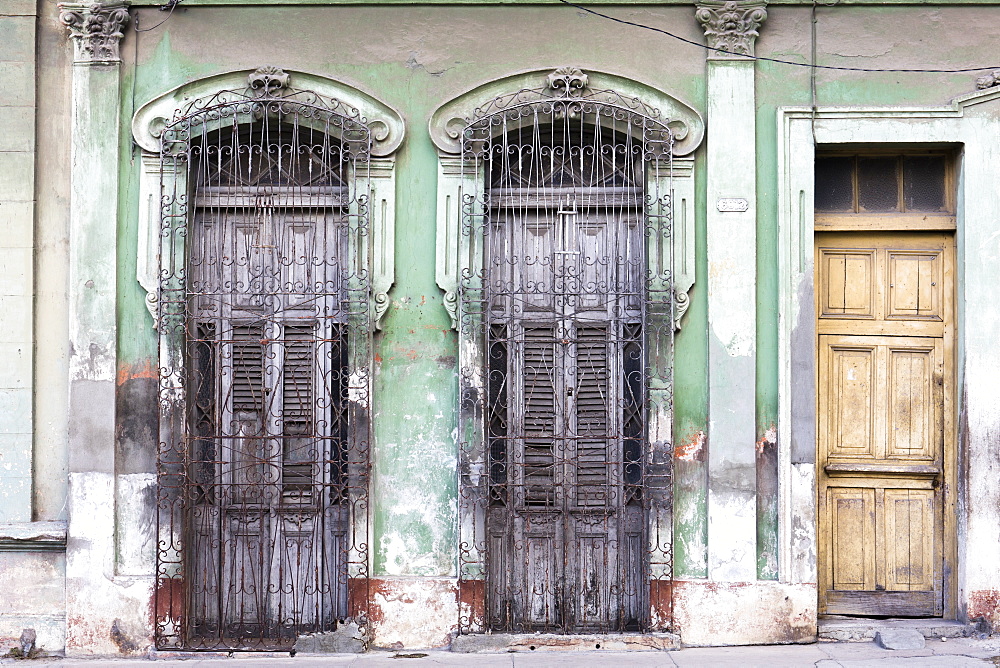 Old doorways and windows, covered by intricate metal gates, Cienfuegos, UNESCO World Heritage Site, Cuba, West Indies, Caribbean, Central America