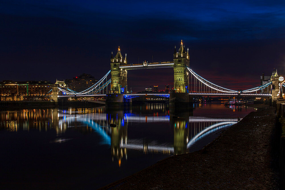 Tower Bridge at night just before sunrise, reflecting in a still River Thames, London, England, United Kingdom, Europe