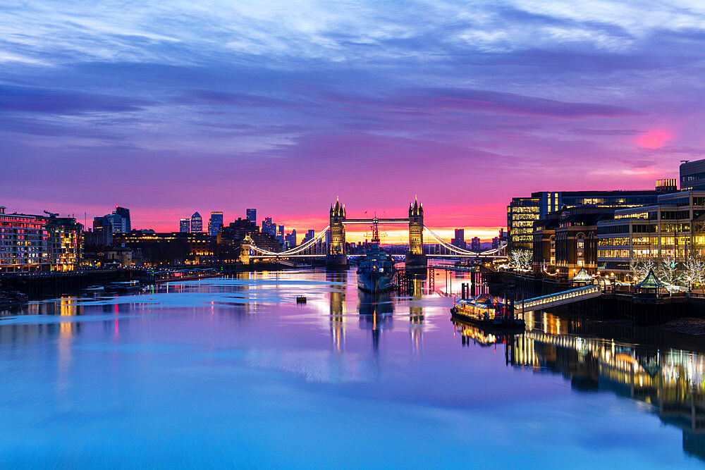 Tower Bridge and HMS Belfast reflecting in a still River Thames at sunset, London, England, United Kingdom, Europe