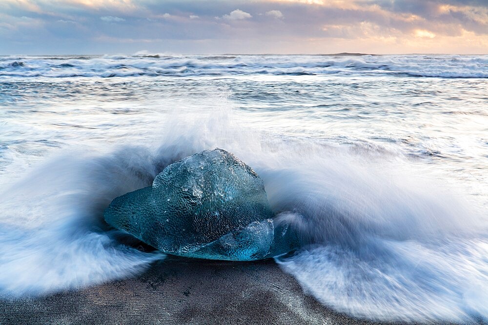 Iceberg from melting glacier on black sand beach near Jokulsarlon glacier lagoon, Vatnajokull National Park, Iceland, Polar Regions