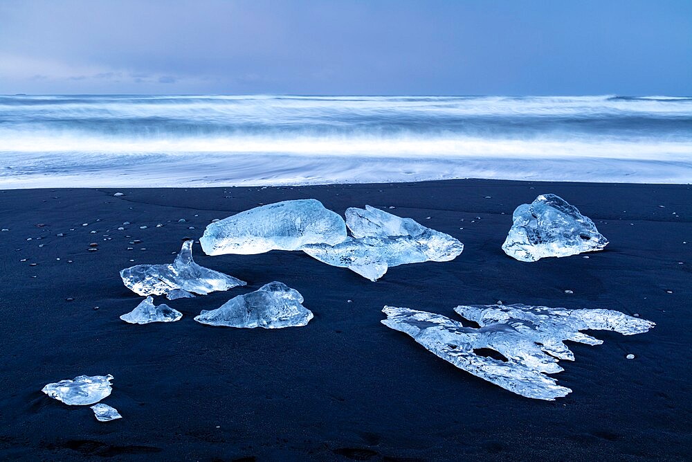 Icebergs from melting glacier on black sand beach near Jokulsarlon glacier lagoon, Vatnajokull National Park, Iceland, Polar Regions