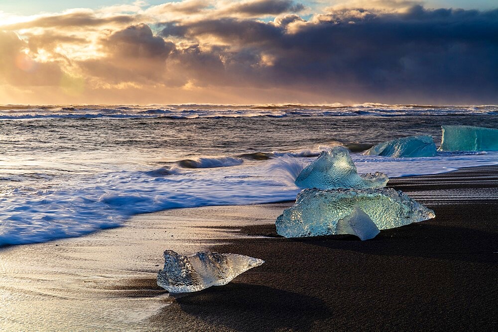 Icebergs from melting glacier on black sand beach near Jokulsarlon glacier lagoon, Vatnajokull National Park, Iceland, Polar Regions