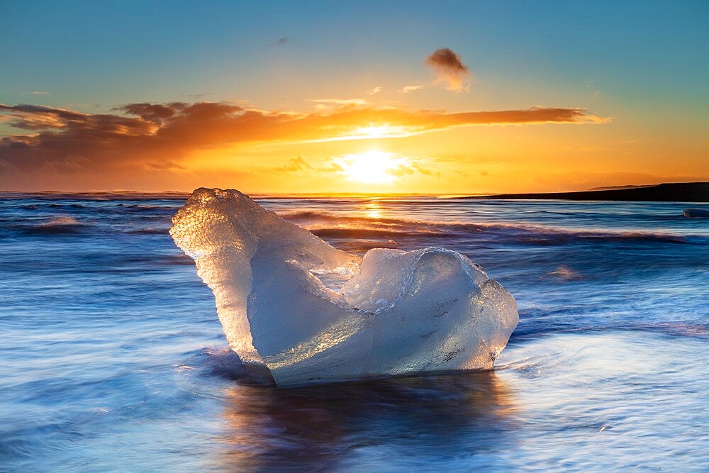 Iceberg from melting glacier on black sand beach near Jokulsarlon glacier lagoon, Vatnajokull National Park, Iceland, Polar Regions