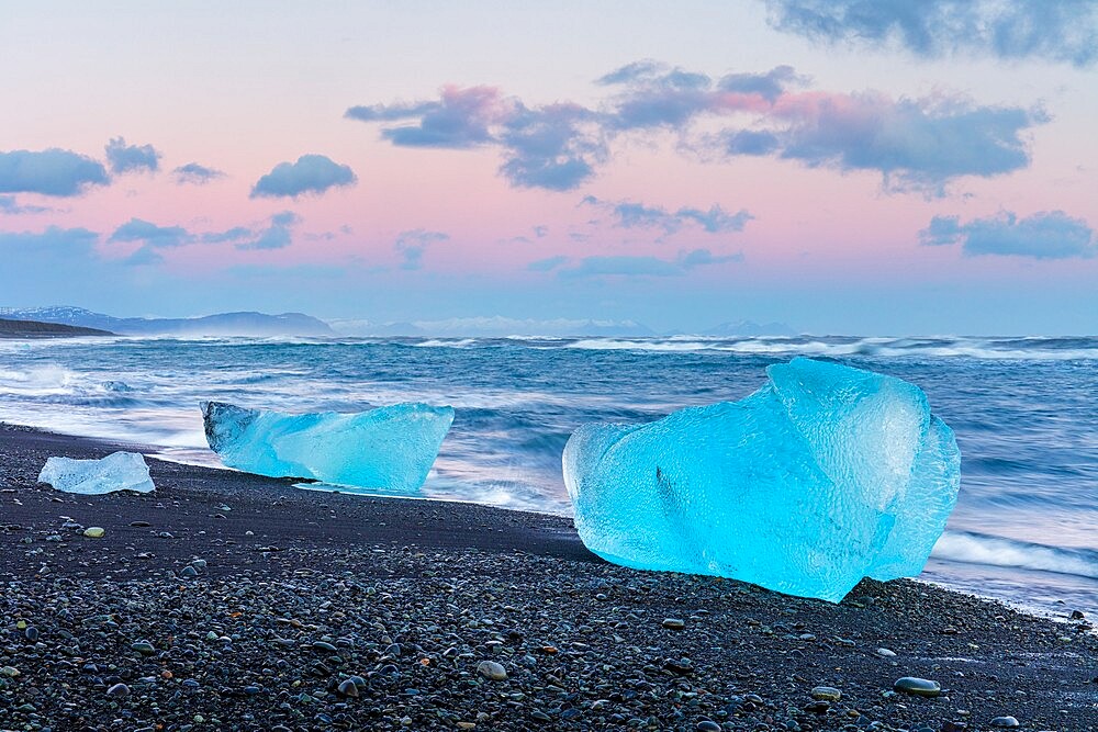 Icebergs from melting glacier on black sand beach near Jokulsarlon glacier lagoon, Vatnajokull National Park, Iceland, Polar Regions