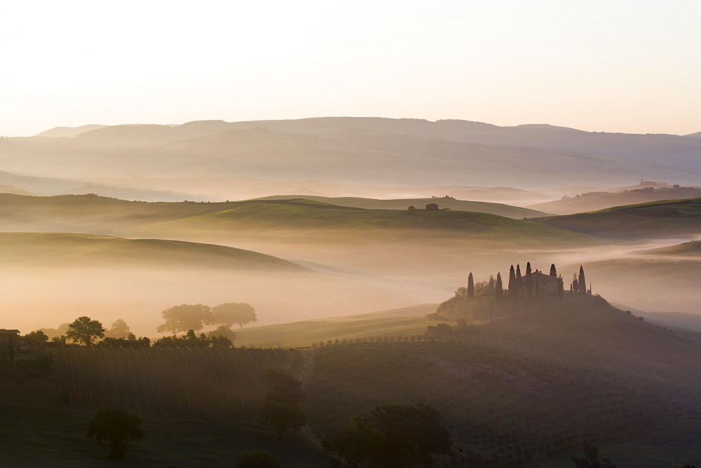 Podere Belvedere and misty hills at sunrise, Val d'Orcia, San Quirico d'Orcia, UNESCO World Heritage Site, Tuscany, Italy, Europe