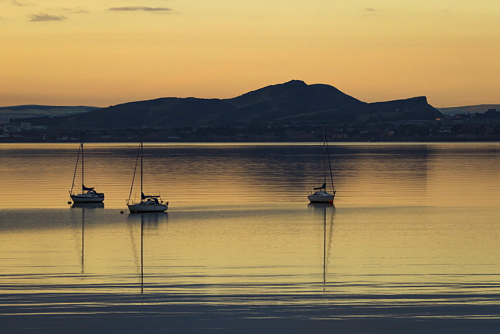 Sailboats at sunrise in Aberdour with Edinburgh in the background, Fife, Scotland, United Kingdom, Europe