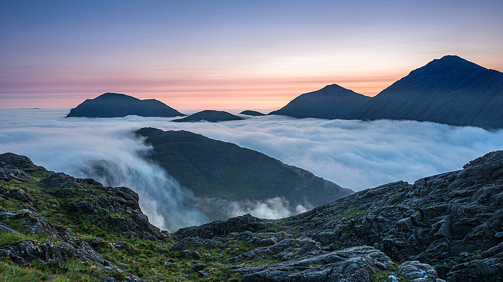 Sunrise behind Bla Bheinn and Marsco with an early morning inversion filling Glen Sligachan and flowing over the minor tops, Isle of Skye, Inner Hebrides, Scotland, United Kingdom, Europe