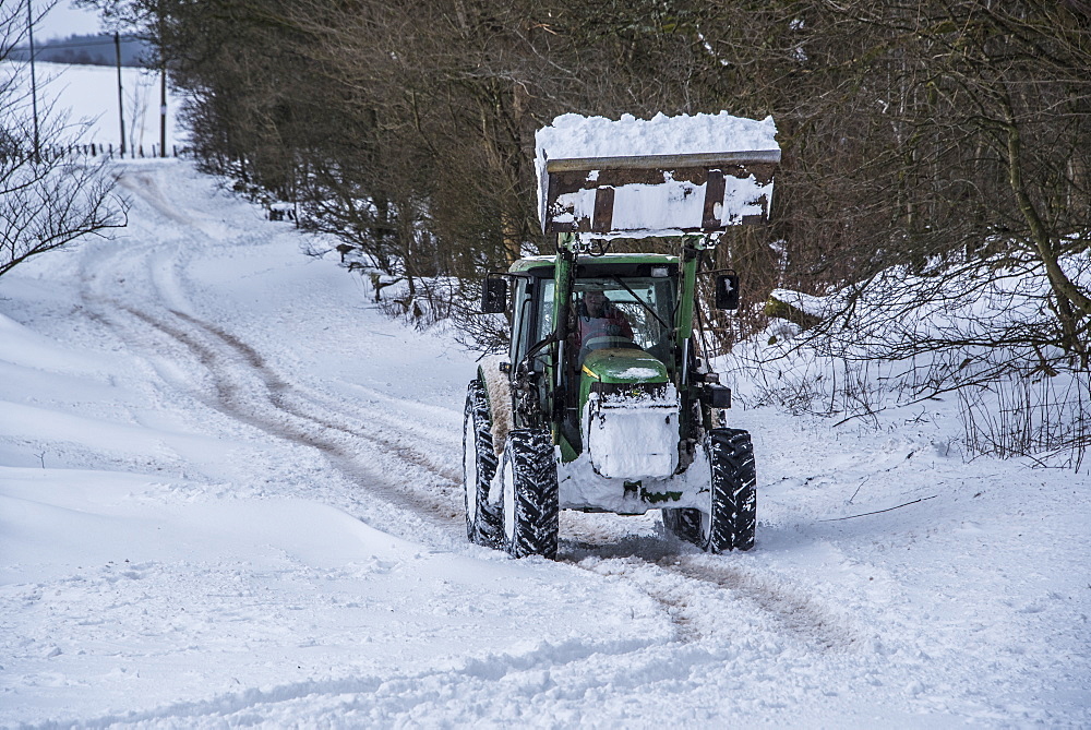 A tractor trying to clear the main road between Lennoxtown and Strathblane, East Dunbartonshire, Scotland, United Kingdom, Europe