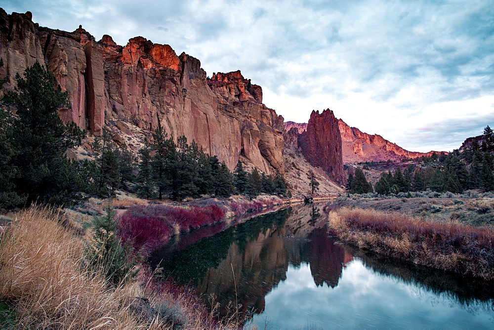 A river running through a valley with large rock formations on either side, Oregon, United States of America, North America