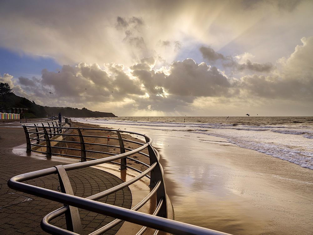 Shimmering sand and railings in warm light Exmouth, Devon, England, United Kingdom, Europe