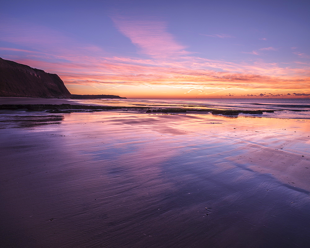 Dawn twilight with clouds reflected on the wet beach at Orcombe Point and Sandy Bay, Exmouth, Devon, England, United Kingdom, Europe