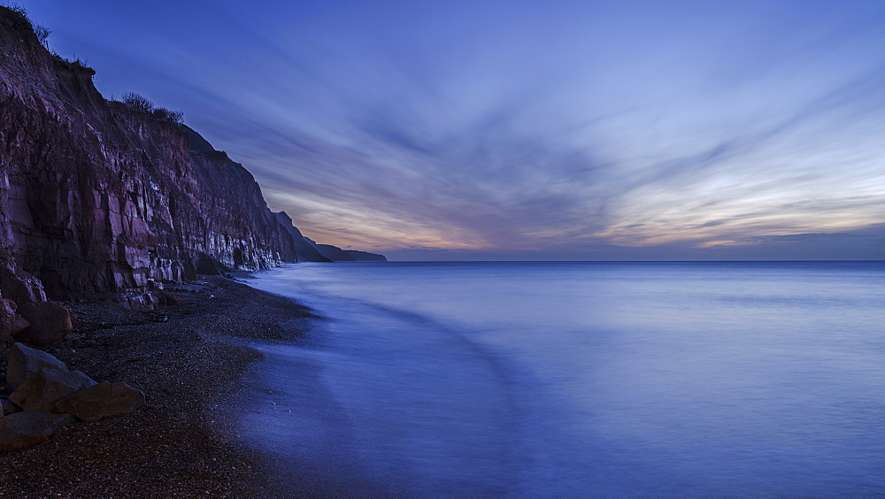 Receding wave beneath cliffs at the picturesque seaside town of Sidmouth, Devon, England, United Kingdom, Europe