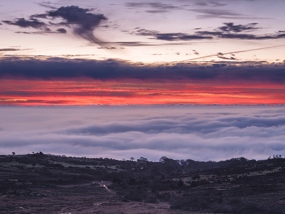 Dawn colours above mist viewed from Saddle Tor, Dartmoor National Park, Bovey Tracey, Devon, England, United Kingdom, Europe