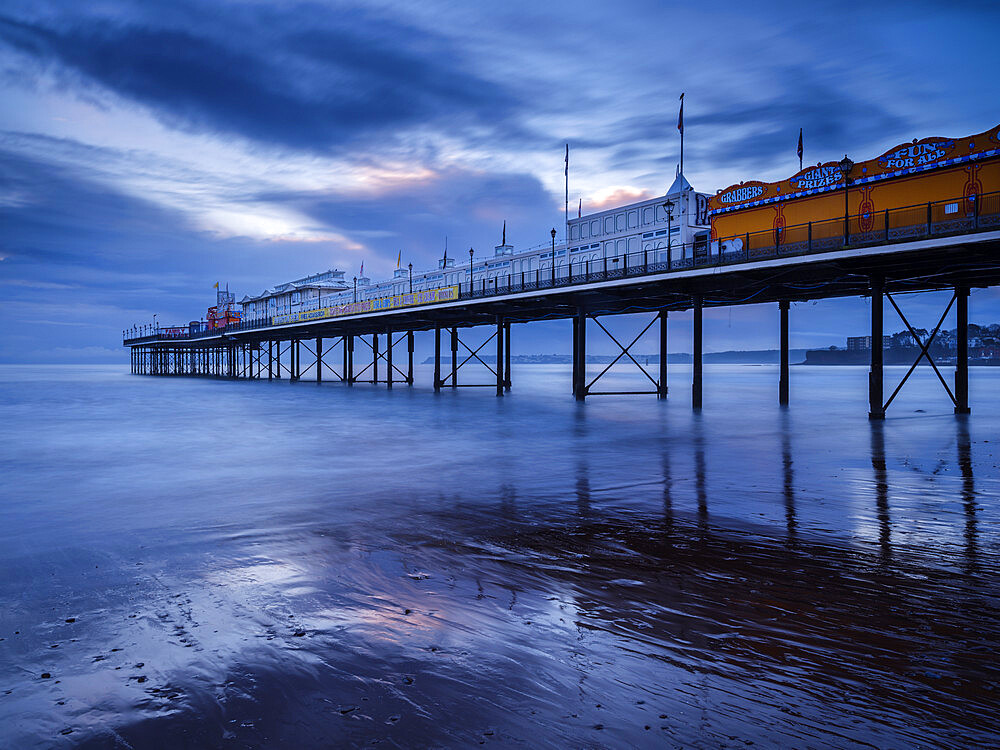 The photogenic Pier in dawn twilight at Paignton, Devon England, United Kingdom, Europe